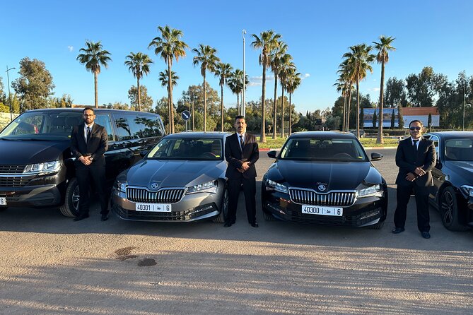 Chauffeurs waiting beside black saloons before a day of pickups